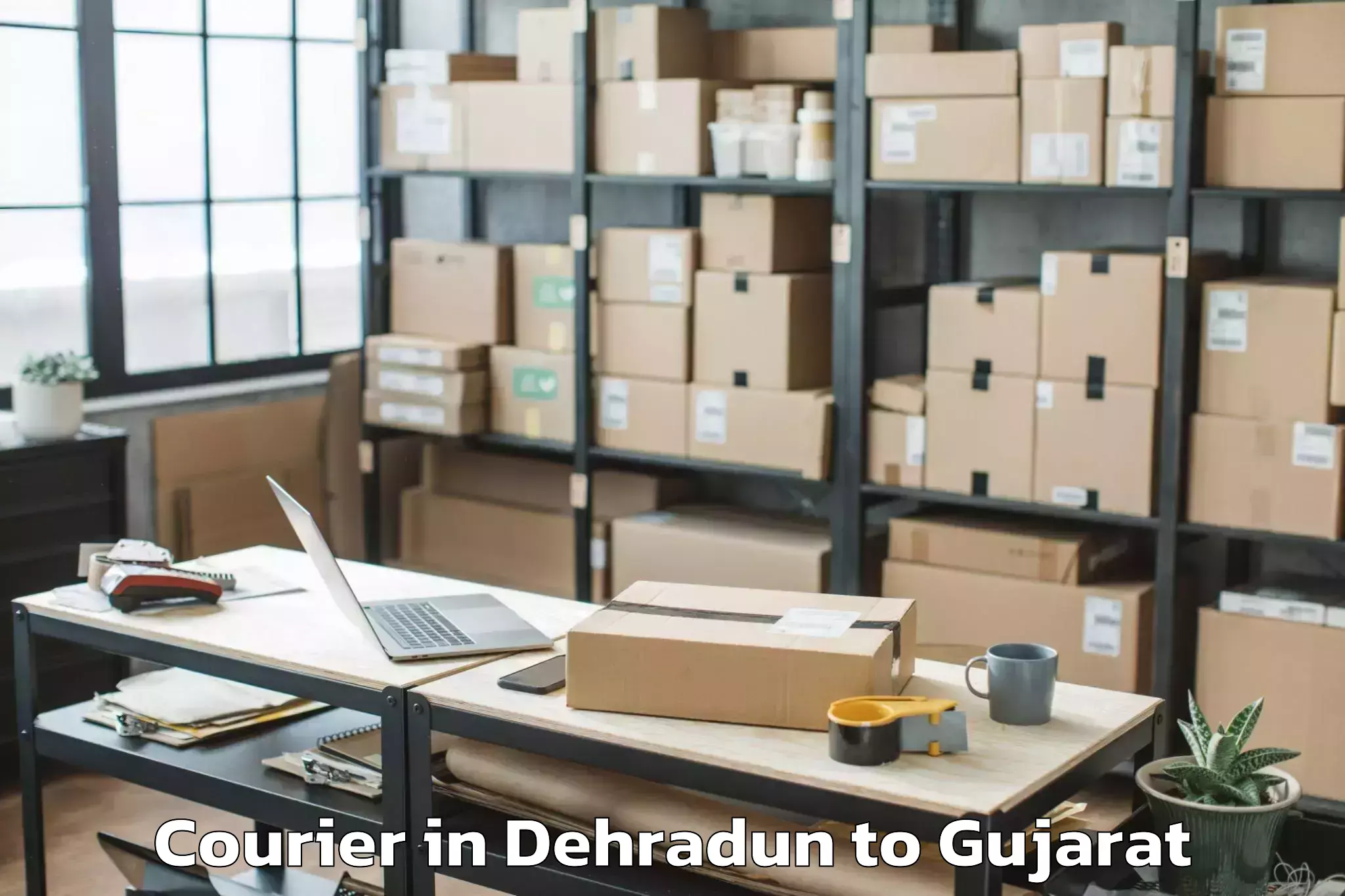 Reliable Dehradun to Kheralu Courier